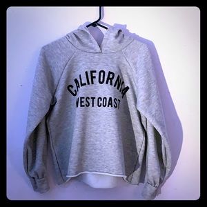 Grey sweatshirt with hood.